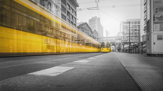 Selective Color Photography of Yellow Train Beside Building