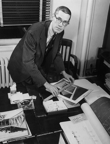 architect in glasses and ruler working on a publication 